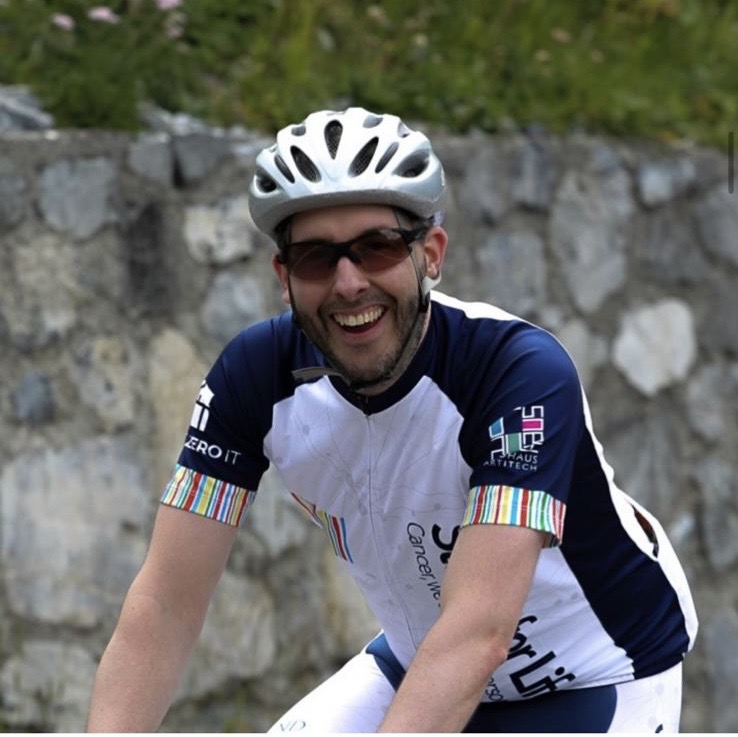 Our colleague Lex riding a bicycle during Stelvio for Life