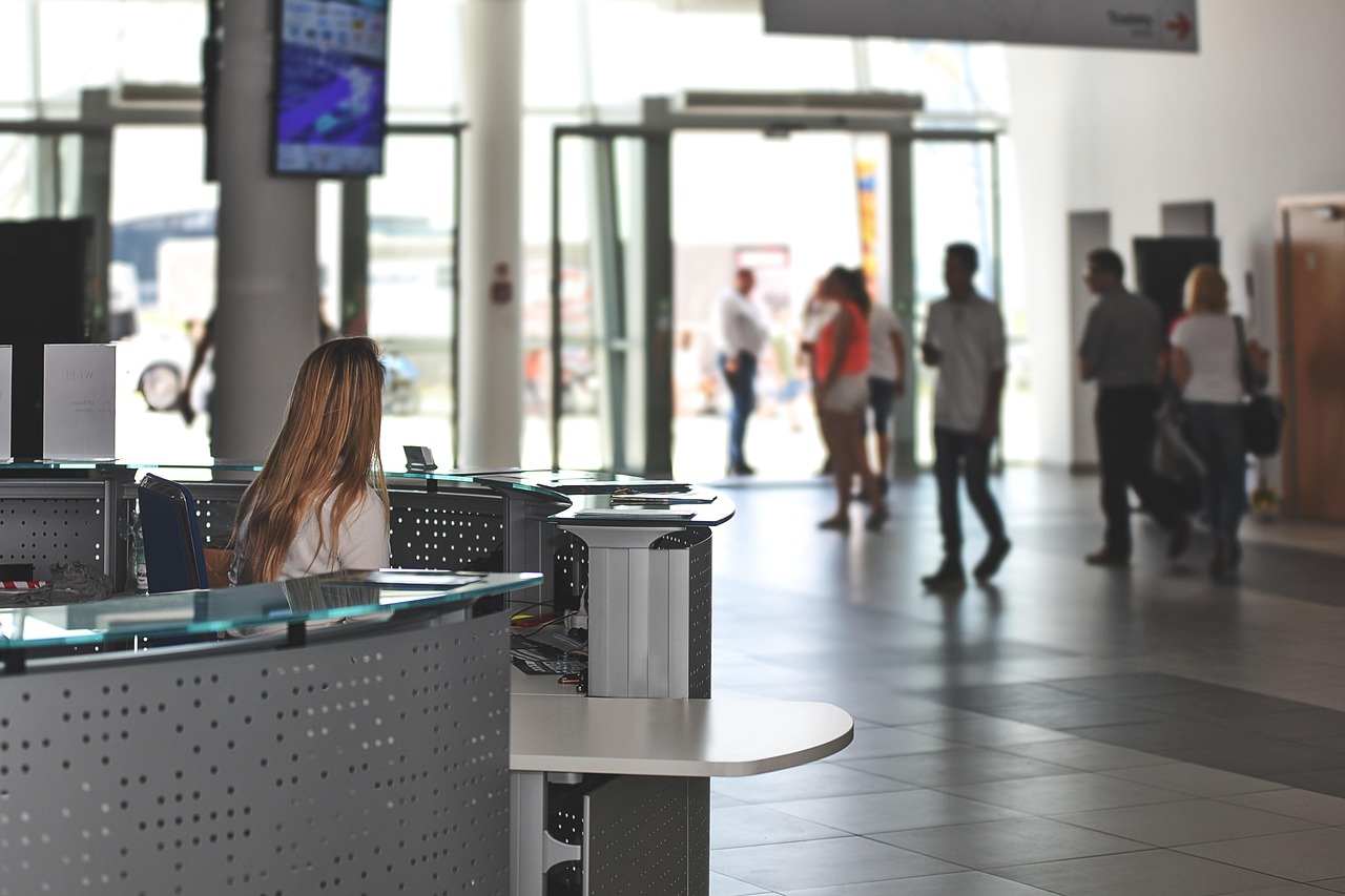 Woman sitting behind reception desk in the hall of a government building